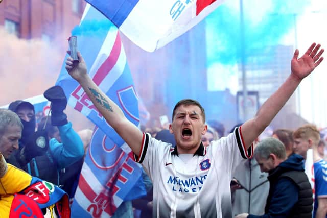 Rangers fans celebrate outside of the Ibrox Stadium after Rangers win the Scottish Premiership title
