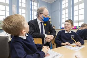 Northern Ireland Education Minister Peter Weir during a visit to Primary 3 class at Springfield Primary School in Belfast as Primary 1 through 3 children return to school. Picture date: Monday March 3, 2021.