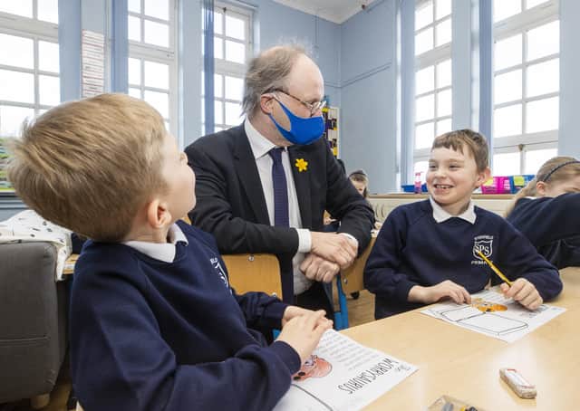Education Minister Peter Weir during a visit to Primary 3 class at Springfield Primary School in Belfast yesterday as Primary 1 through 3 children returned to school