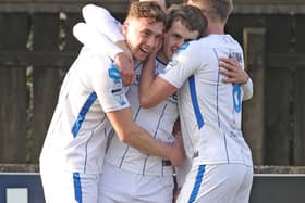 Ben Doherty is mobbed by his Coleraine team-mates after his spectacular winner