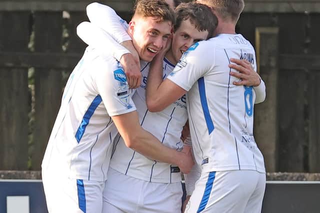 Ben Doherty is mobbed by his Coleraine team-mates after his spectacular winner
