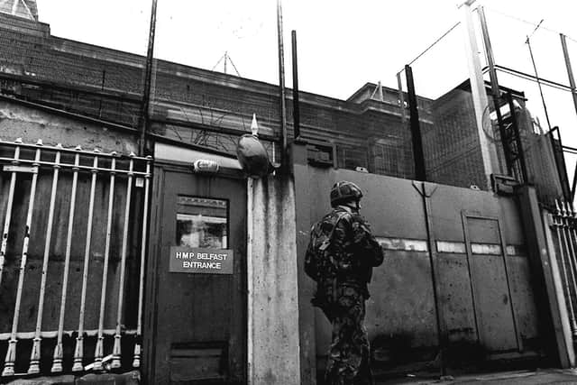 A soldier walks past the sign for HMP Belfast, as it was formerly known