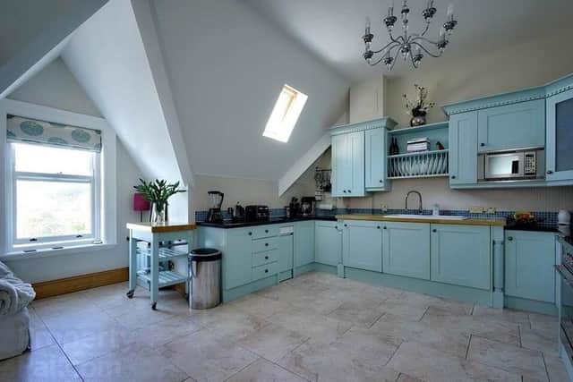 The property features a Thomas Bell Kitchen with range of integrated appliances / Casual Living Area with Lough views
