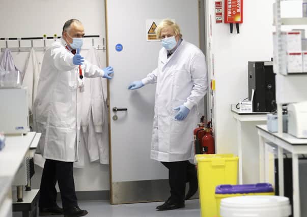 Prime Minister Boris Johnson (right) meets with Professor Jose Bengoechea during a visit to the Wellcome-Wolfson Institute For Experimental Medicine at Queen's University Belfast on Friday. Photo: Peter Morrison/PA Wire