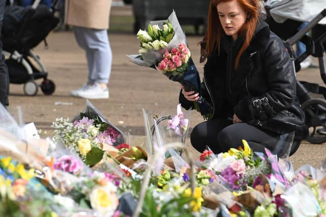 Women and men laid flowers in honour of Sarah Everard at the band stand in Clapham Common, London.
