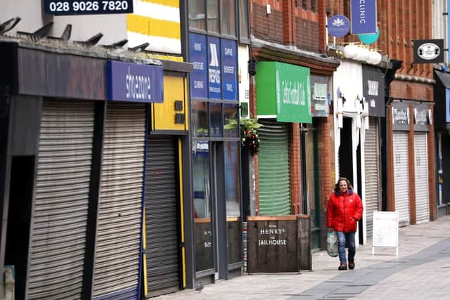 A man walks through a deserted Belfast city centre as Northern Ireland entered a new extended lockdown on Boxing Day whilst the number of coronavirus cases remain high.