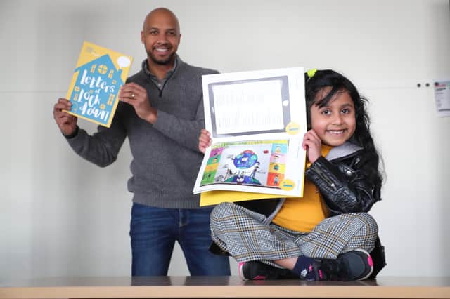 Q Radio presenter and CiNI Ambassador, Ibe Sesay, is pictured with Koushikha Dontham (age 7) a P3 pupil from Lisnasharragh Primary School whose colourful drawing is the first entry in the booklet.