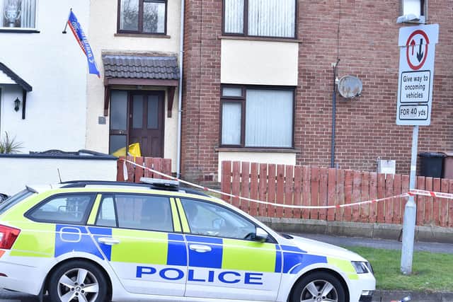 Police at the scene of the deaths in Derrycoole Way on Saturday morning