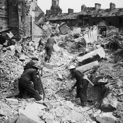 Rescue workers search through rubble after the Belfast Blitz on May 7 1941