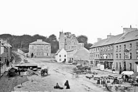 This is beautiful old photograph of the Market Square in Dungannon, Co Tyrone from the archives of the National Library of Ireland. It shows traders set up in anticipation of sales to the people who must surely come to the market. Catalogue range circa 1865-1914. Definitely after 1871 (tower). And before 1891 (post office) Likely circa1800 (businesses). NLI Ref: L_CAB_02160. Picture: National Library of Ireland