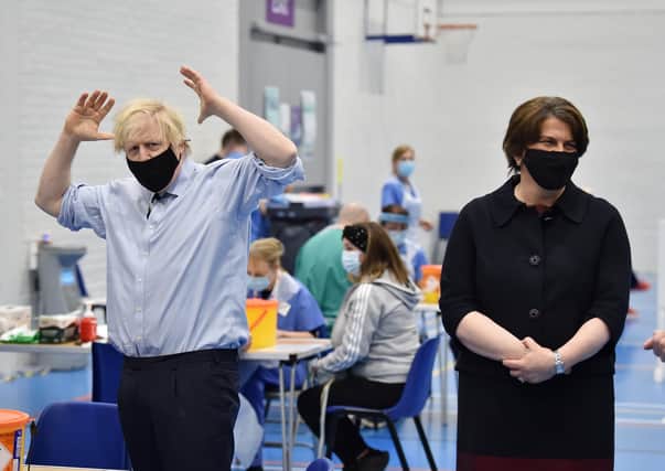 Prime Minister Boris Johnson alongside First Minister Arlene Foster during a visit to the Lakeland Forum vaccination centre in Enniskillen, Northern Ireland. Picture date: Friday March 12, 2021.