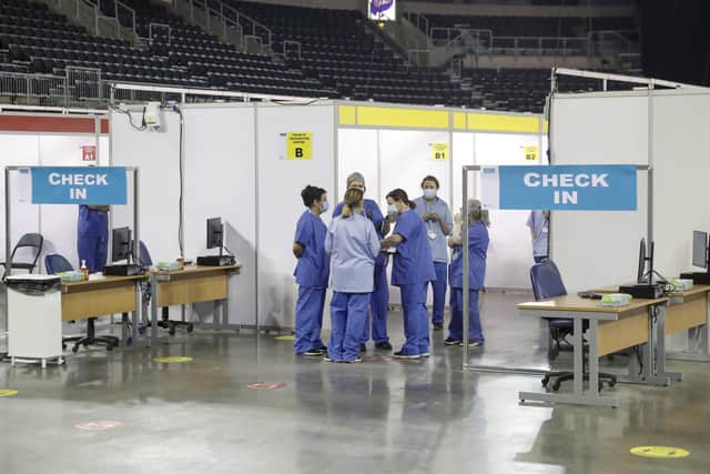 Healthcare staff pictured inside the SSE Arena in Belfast on Monday.