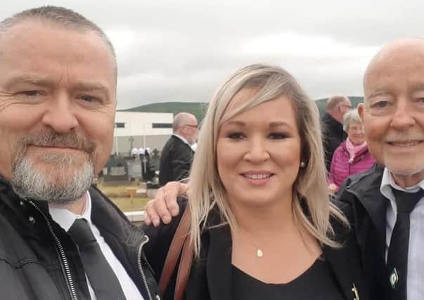 Michelle O'Neill posing for a selfie with two attendees at Bobby Storey's funeral.