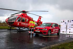 Glenn O'Rorke, Air Ambulance NI Operational Lead, launches the Osborne Car Competition alongside the helicopter at the Air Ambulance NI base. Over 400 tickets sold so far