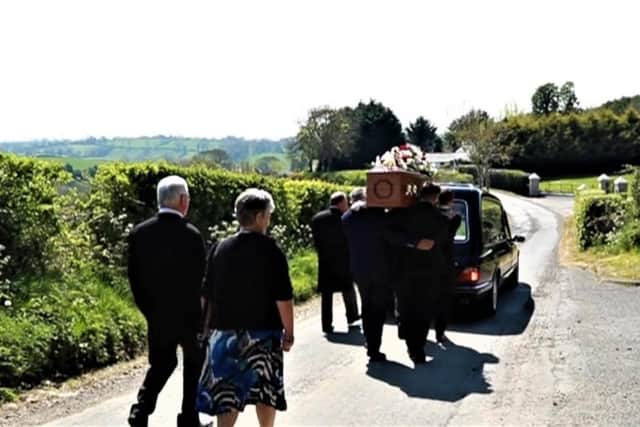 A small group following the hearse ahead of Charlie Poots' burial