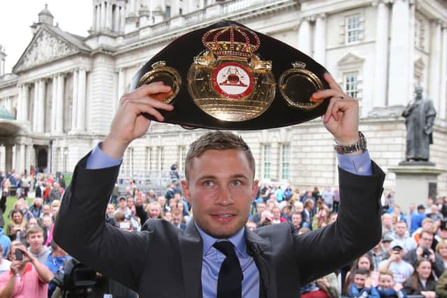 Carl Frampton lifts the belt in front of fans during his homecoming event at Belfast City Hall in 2016. Pic by PA
