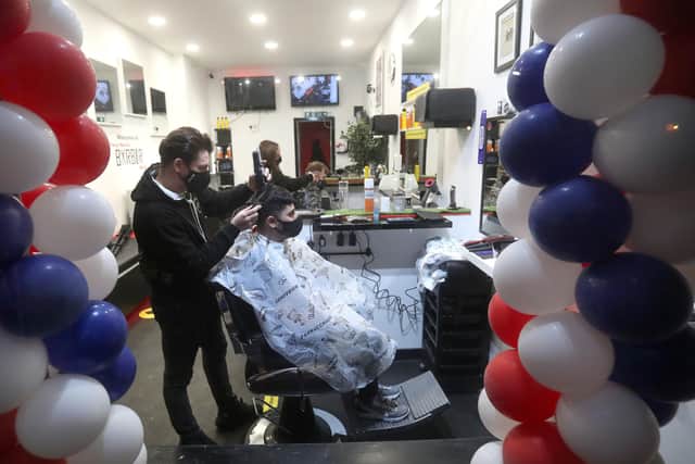 Barber Tony Mann, who opened yesterday at 6am, trims Max Mann's hair at Tony Mann's Barber Shop in Giffnock near Glasgow as barbers reopen across Scotland on Easter Monday. Photo: Andrew Milligan/PA Wire