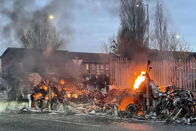 The wreckage of a Translink Metrobus on fire on the Shankill Road in Belfast during disorder on Wednesday. Photo: Liam McBurney/PA Wire