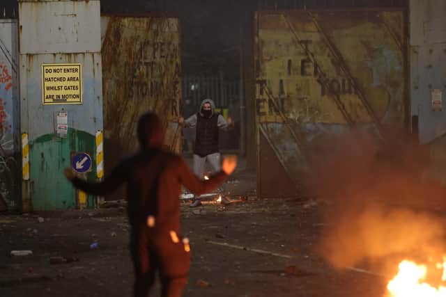 The peaceline gates at Lanark Way are forced open on Wednesday evening by rioting youths. Photo: Pacemaker Belfast