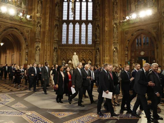 Members of Parliament process through the Central Lobby from the Lords chamber back to the House of Commons following the State Opening of Parliament by Queen Elizabeth II, in the House of Lords at the Palace of Westminster in London