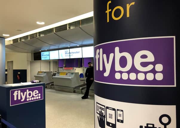 A man standing by a check-in desk at Manchester Airport as Flybe, Europe's biggest regional airline, has collapsed into administration