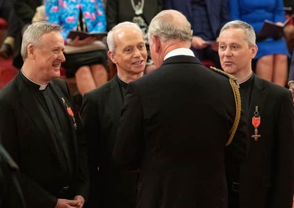 The Priests are given their MBE medals by the Prince of Wales at Buckingham Palace