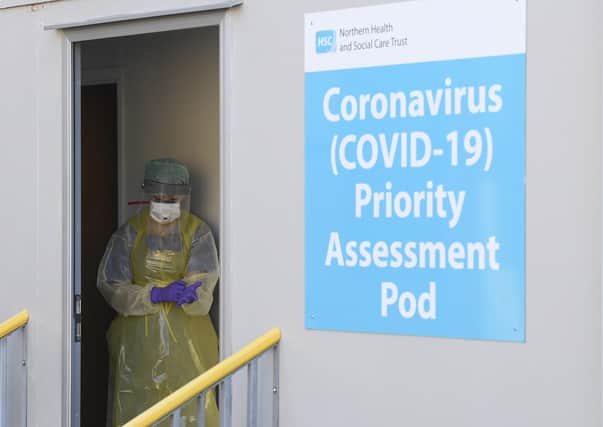 A nurse at Antrim Area Hospital's Covid-19 testing pod preparing for a test