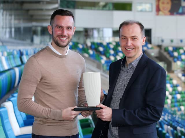 Andrew Waterworth collects the Belleek trophy from NIFWA Chairman Stuart McKinley