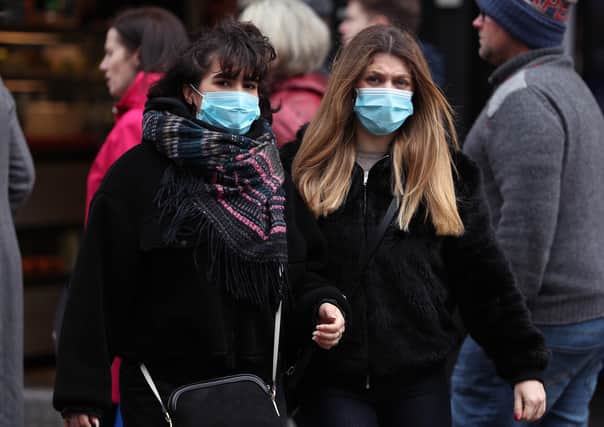People wearing face masks in central London this weekend, when a third person in the UK died from coronavirus. Photo: Yui Mok/PA Wire