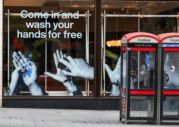 A sign in the window of a Lush store in Liverpool offering a free hand wash service. Photo: Peter Byrne/PA Wire
