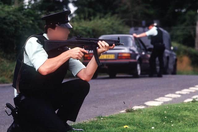 An RUC man keeps guard at a checkpoint. Dr Dingley writes: "The security forces had to operate according to law, wearing recognisable uniforms, carrying arms openly, operating within a formal control system"