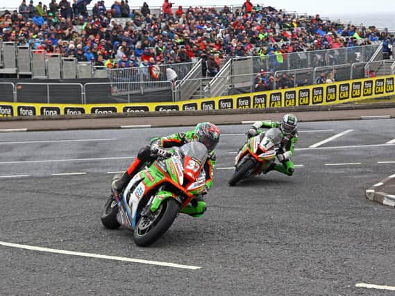Crowds watch on during last year's North West 200 as James Hillier and Glenn Irwin entertain the crowds at York Corner in the Superbike race.