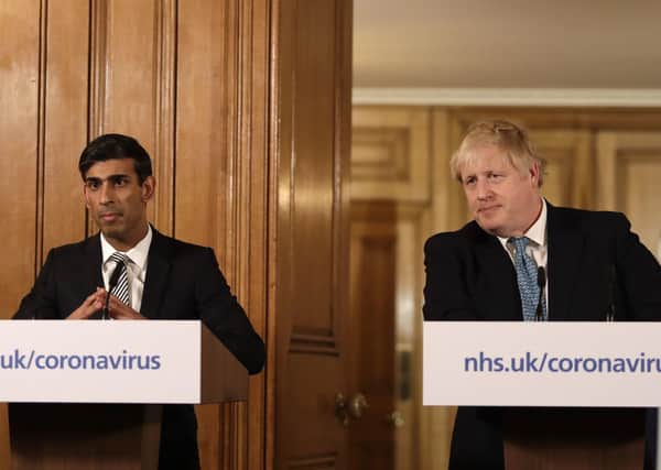 Chancellor Rishi Sunak with Prime Minister Boris Johnson announces radical financial measures at a media briefing in Downing Street onTuesday March 17, 2020. Photo: Matt Dunham/PA Wire