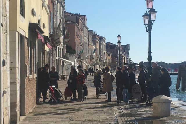 People queue for food in Venice, Italy. (Photo: PA Wire)