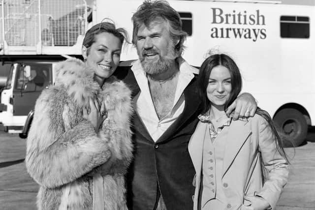 American singing star Kenny Rogers at London's Heathrow airport when he arrived with his two favourite ladies - his bride of a few weeks, television star Marianne Gordon (left) and Crystal Gayle. Rogers, whose husky voice carried him as a TV and music star across genres, has died aged 81
