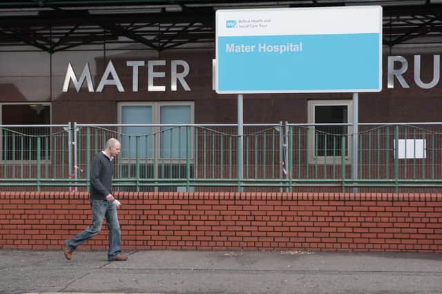 A member of the public walks past the Mater Hospital's entrance on the Crumlin Road
