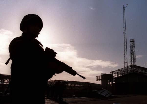 A soldier stands guard at a military base in Northern Ireland in 1999