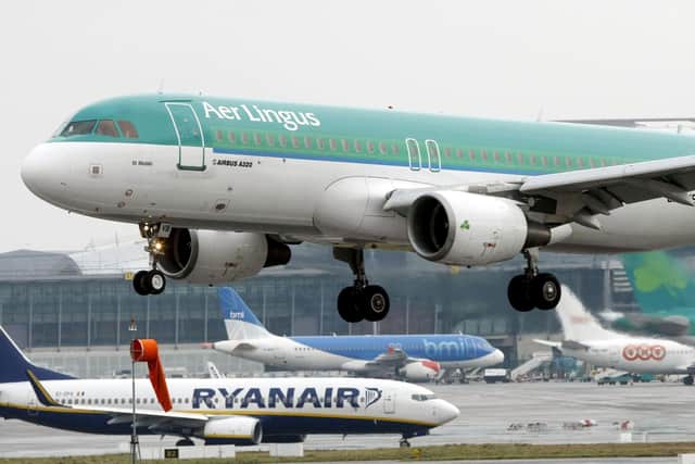 Aer Lingus Airbus A320 landing as a Ryanair plane taxi's at Dublin Airport