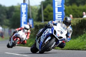 Guy Martin (Tyco Suzuki) leads Michael Dunlop (Honda Legends) in the feature Superbike race at the 2013 Ulster Grand Prix.