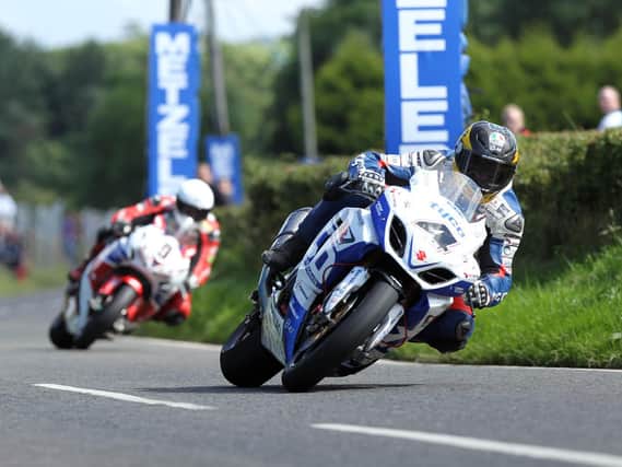 Guy Martin (Tyco Suzuki) leads Michael Dunlop (Honda Legends) in the feature Superbike race at the 2013 Ulster Grand Prix.