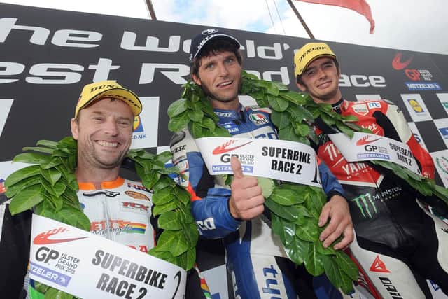 Guy Martin celebrates his victory in the second Superbike race at the Ulster Grand Prix with runner-up Bruce Anstey (left) and Conor Cummins.
