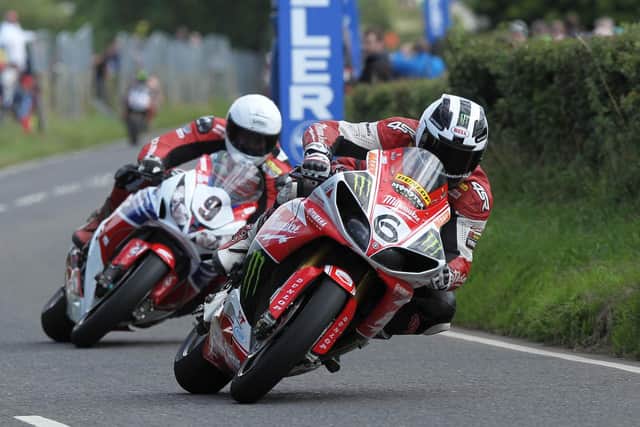 William Dunlop ( Milwaukee Yamaha) leads his brother Michael (Honda Legends) through Rock Bends in the main Superbike race.