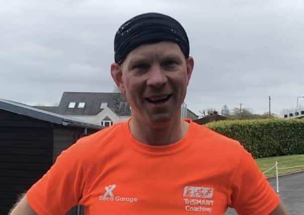Keith Clarke after completing a full marathon in his driveway while pushing a wheelbarrow, to raise money for the NHS ire