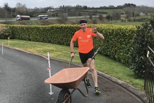 Keith Clarke during his attempt to complete a full marathon in his driveway while pushing a wheelbarrow, to raise money for the NHS