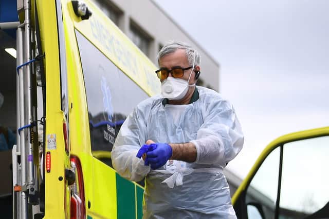 A paramedic wearing personal protective equipment