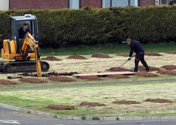 Council workers preparing burial plots at the Sixmile Cemetery in Antrim