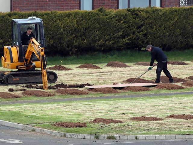 Council workers preparing burial plots at the Sixmile Cemetery in Antrim