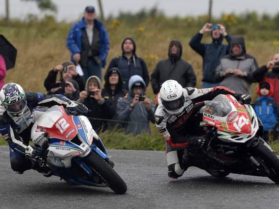 Dean Harrison (5) and Dan Kneen (14) at the hairpin the 2014 Superstock race at the Ulster Grand Prix.