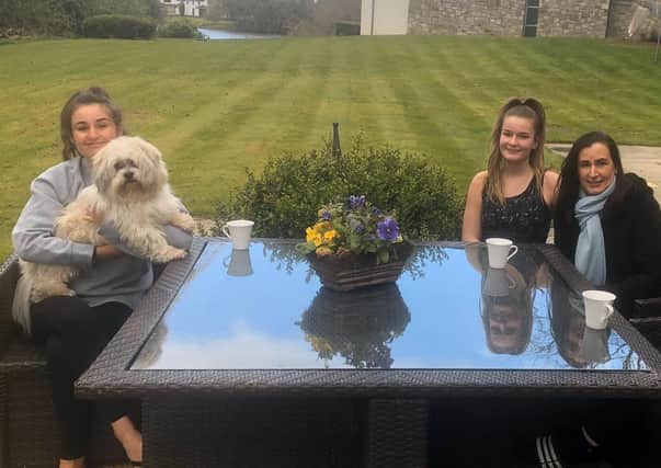 Amy (left) at home in Hillsborough with her sister Anna, mum Gillian and dog Riley