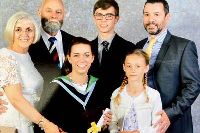 Kathryn with family members at a graduation